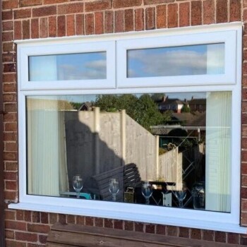 A window with a reflection of the sky in it.