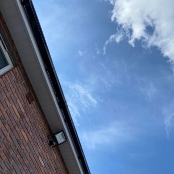 A brick building with a sky background