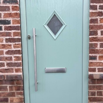 A door with a diamond shaped window on it.