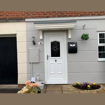 A white door with a flower design on it.