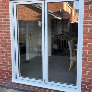 A window with two glass panes on the outside of it.