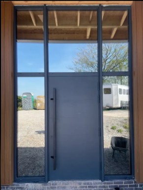 Glass door with metal frame and handle.