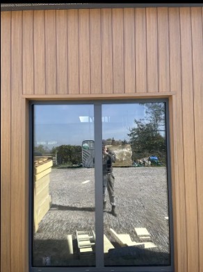 Reflection in window with wooden frame.