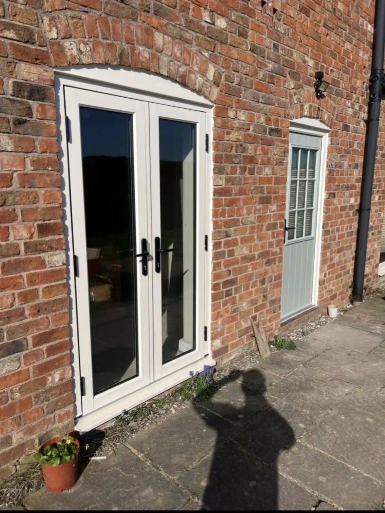 Brick wall with glass door and window.