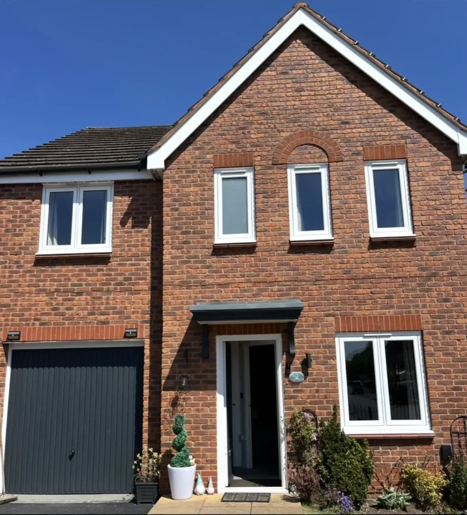 Brick house with garage and front door.