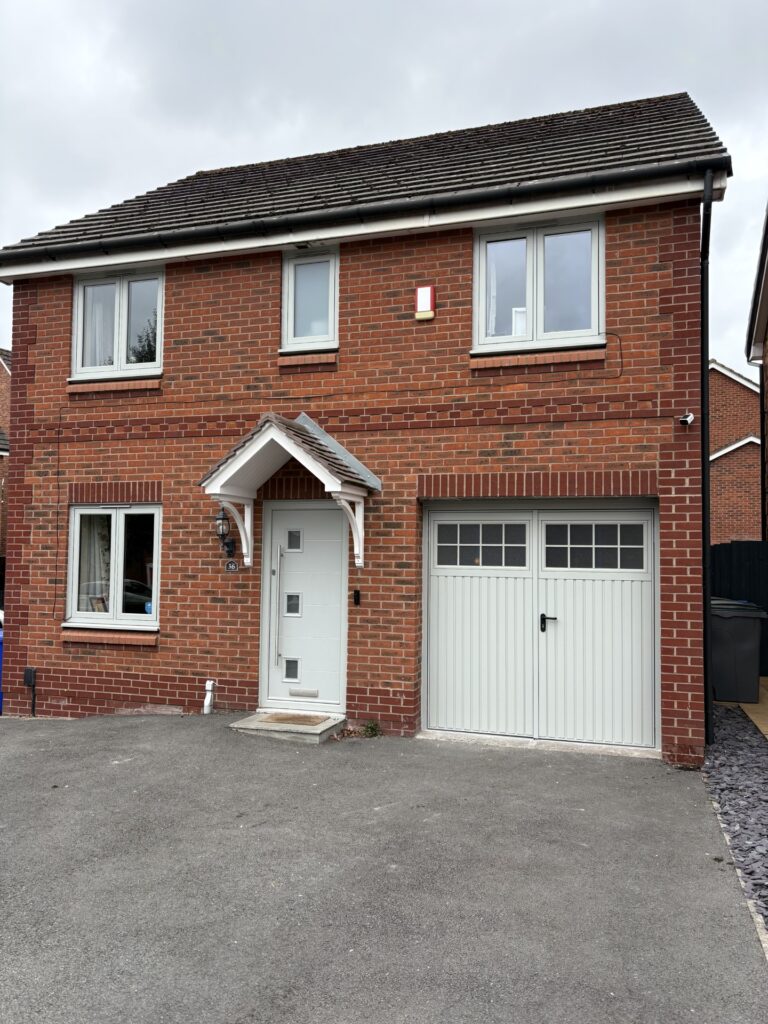 Brick house with garage and driveway.