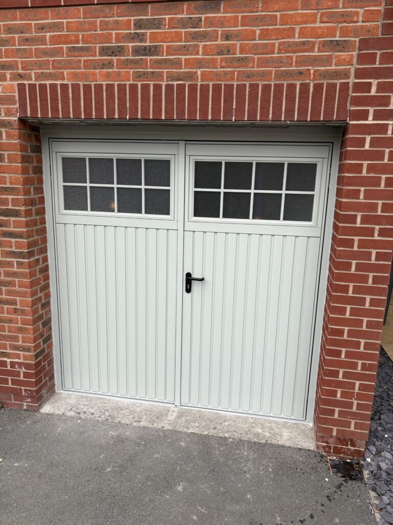 White garage door with brick surroundings.